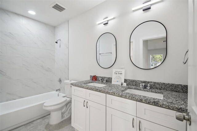 full bathroom with toilet, tiled shower / bath, and vanity