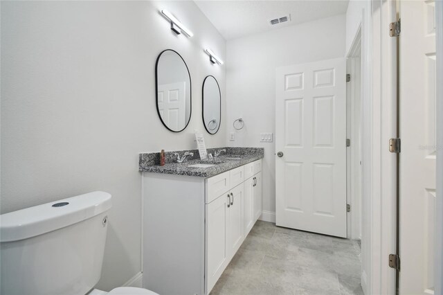 bathroom featuring toilet and vanity