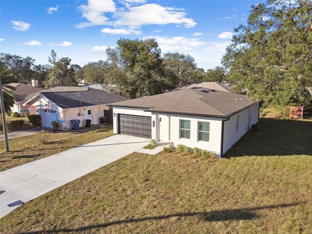 ranch-style house featuring a garage and a front yard