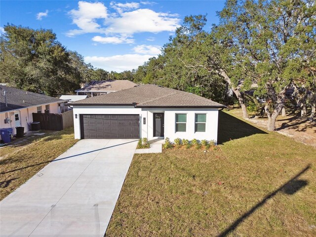 view of front of home with a front lawn and a garage