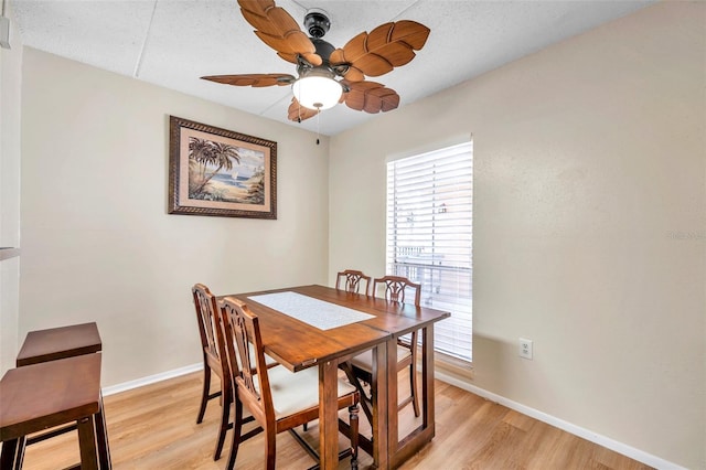 dining area with a textured ceiling, ceiling fan, and light hardwood / wood-style floors