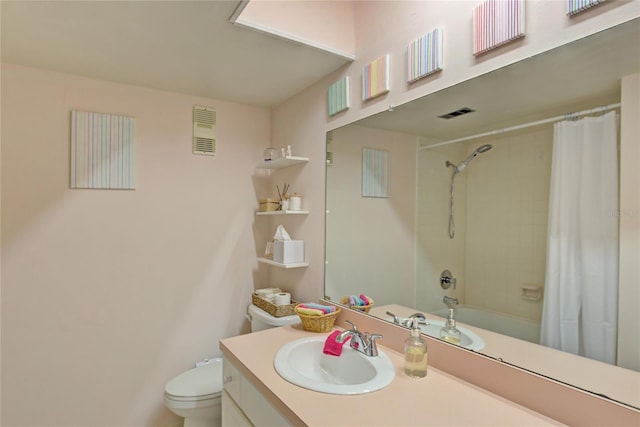 full bathroom with vanity, shower / tub combo, and toilet