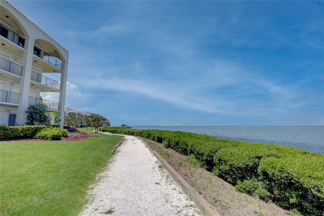 view of community with a yard and a water view