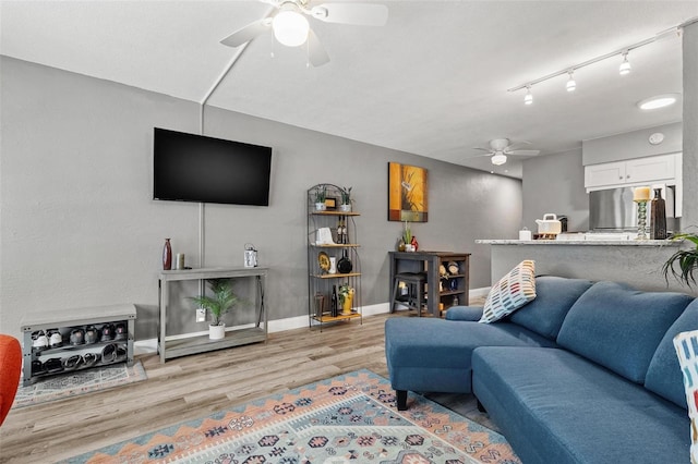 living room featuring light wood-type flooring and ceiling fan