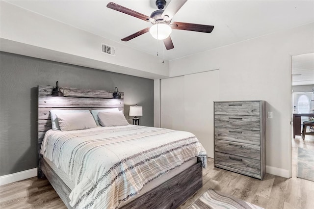 bedroom with ceiling fan and light hardwood / wood-style flooring