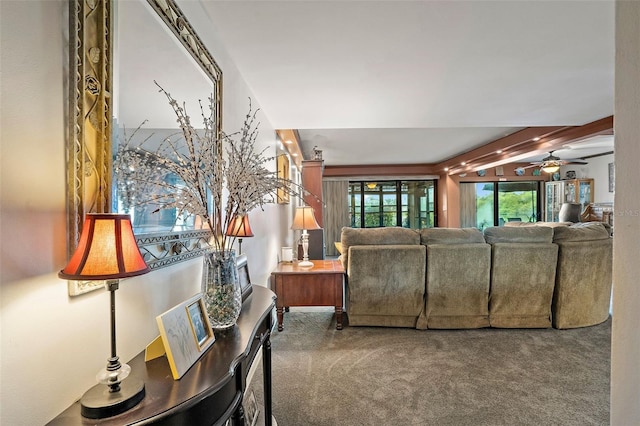 living room featuring ceiling fan, carpet, and beam ceiling