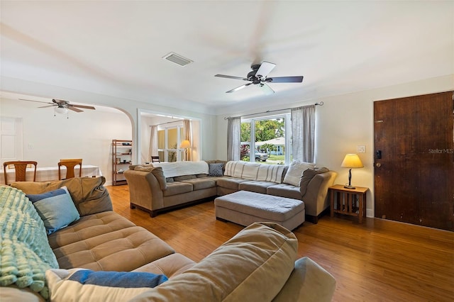 living room featuring ceiling fan and light wood-type flooring