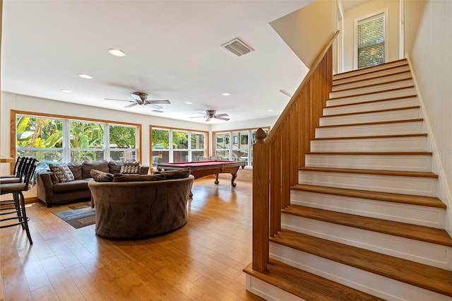 interior space with wood-type flooring, plenty of natural light, ceiling fan, and pool table