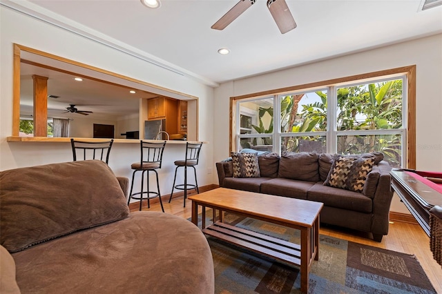 living room featuring ceiling fan and hardwood / wood-style flooring