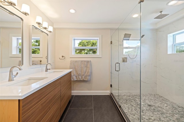 bathroom featuring tile patterned floors, vanity, and a shower with shower door