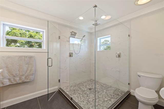 bathroom with tile patterned floors, toilet, and an enclosed shower