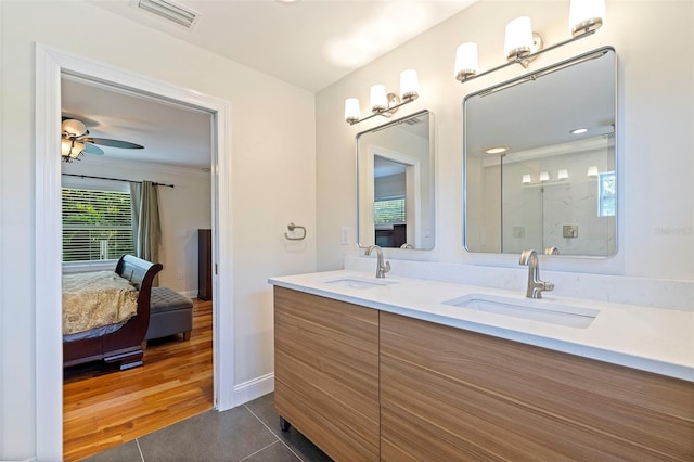 bathroom with tile patterned floors, ceiling fan, vanity, and walk in shower