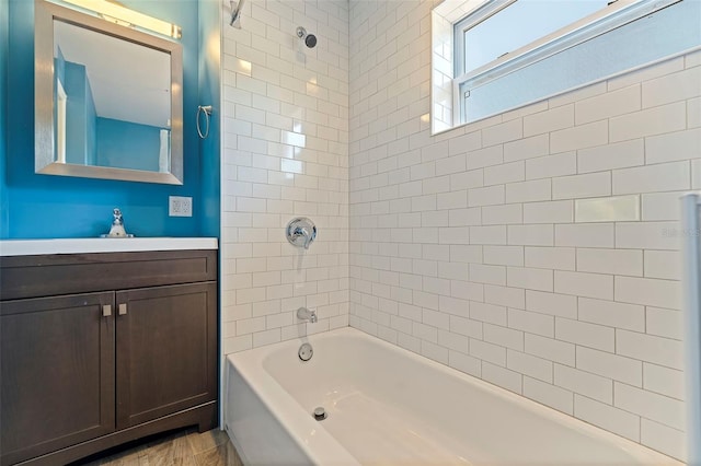 bathroom featuring vanity and tiled shower / bath