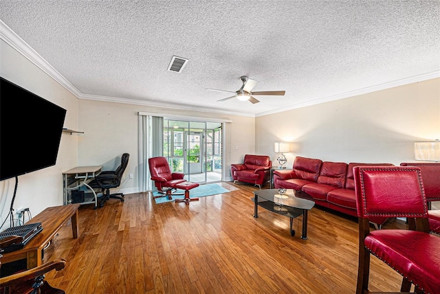 living room with hardwood / wood-style floors, a textured ceiling, ceiling fan, and crown molding