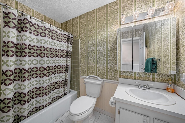 full bathroom featuring vanity, tile patterned floors, shower / bath combination with curtain, toilet, and a textured ceiling