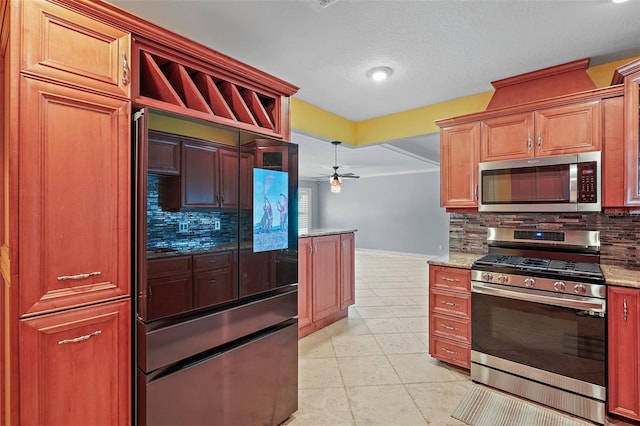 kitchen featuring stainless steel appliances, light stone counters, tasteful backsplash, and ceiling fan