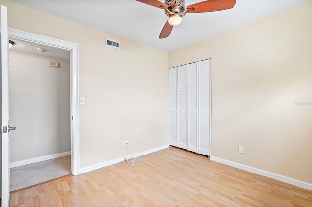 unfurnished bedroom with a closet, ceiling fan, and light hardwood / wood-style flooring