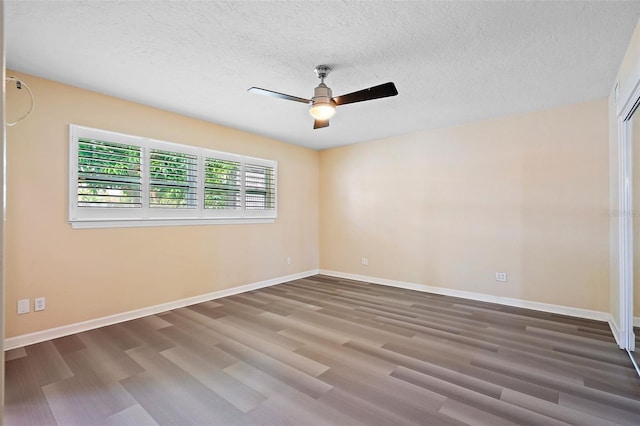 unfurnished room featuring ceiling fan, wood-type flooring, and a textured ceiling