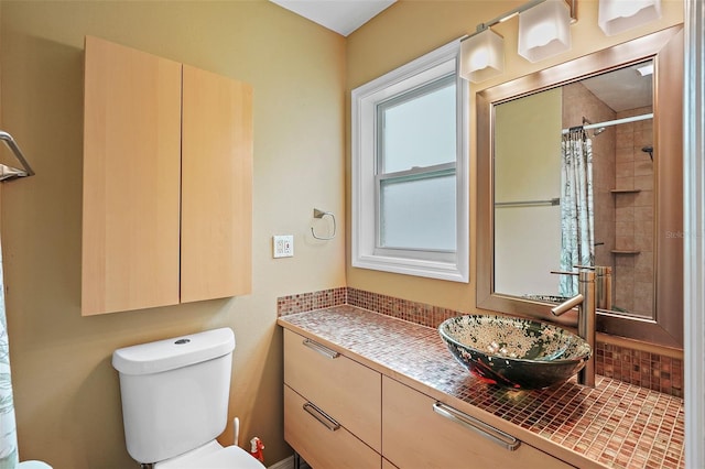 bathroom featuring vanity, toilet, and walk in shower