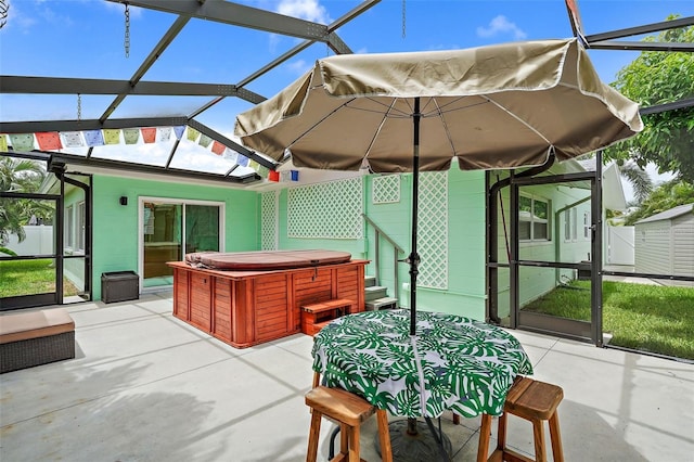 view of patio featuring a lanai and a hot tub