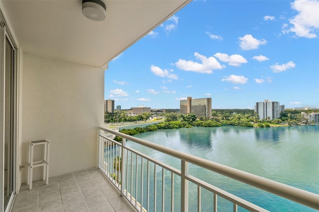 balcony featuring ceiling fan and a water view