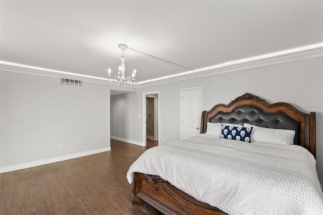 bedroom featuring dark hardwood / wood-style flooring and a chandelier