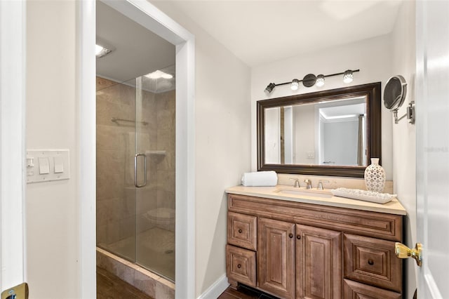 bathroom featuring walk in shower and vanity