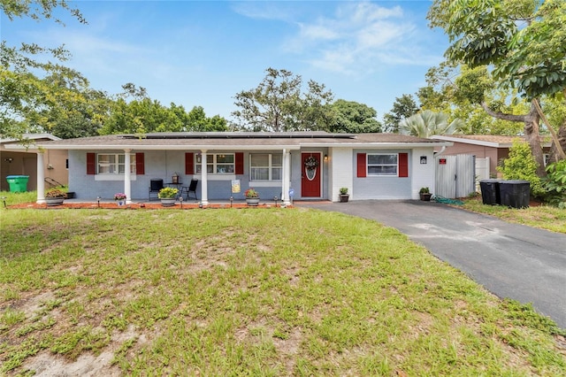 single story home with covered porch and a front lawn