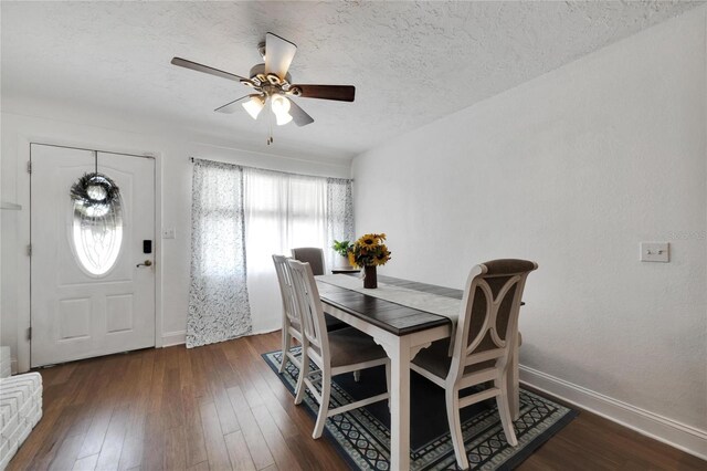 dining space with dark hardwood / wood-style floors, a textured ceiling, and ceiling fan