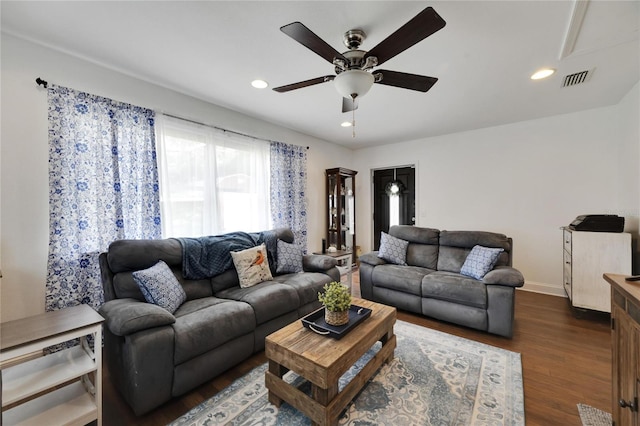 living room with dark hardwood / wood-style floors and ceiling fan