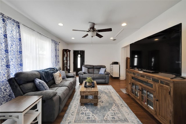 living room featuring dark hardwood / wood-style floors and ceiling fan