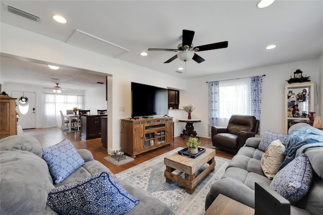 living room featuring ceiling fan and wood-type flooring