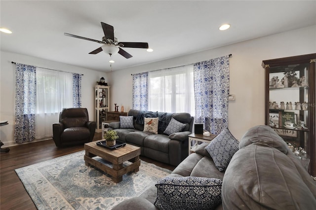 living room featuring dark hardwood / wood-style floors and ceiling fan