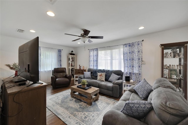 living room featuring wood-type flooring and ceiling fan