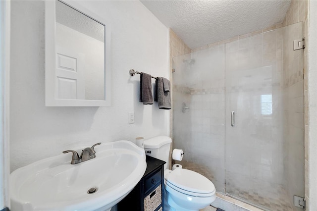 bathroom with toilet, an enclosed shower, a textured ceiling, and sink