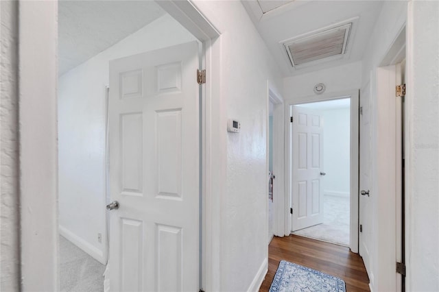 corridor with lofted ceiling and wood-type flooring