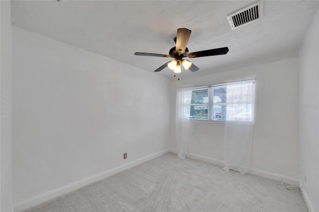 carpeted spare room with ceiling fan