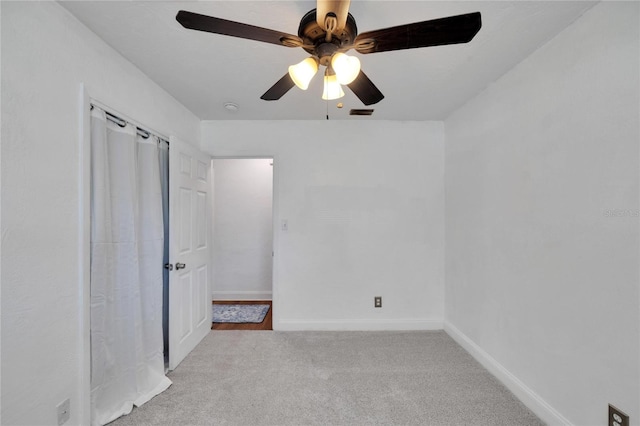 unfurnished bedroom featuring light carpet and ceiling fan