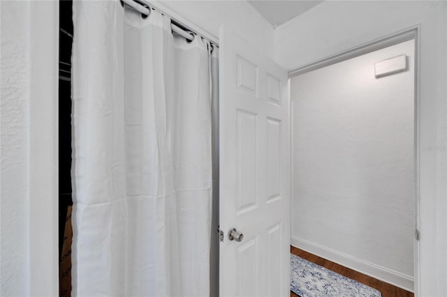 bathroom with hardwood / wood-style flooring