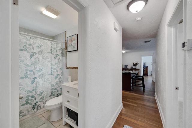 full bathroom featuring toilet, shower / bath combination with curtain, vanity, and wood-type flooring