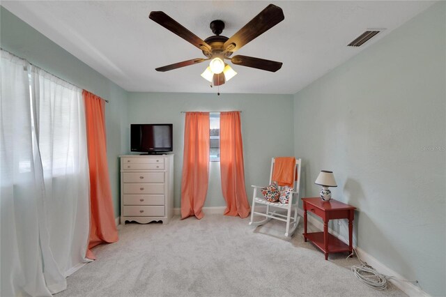 sitting room featuring ceiling fan and light colored carpet