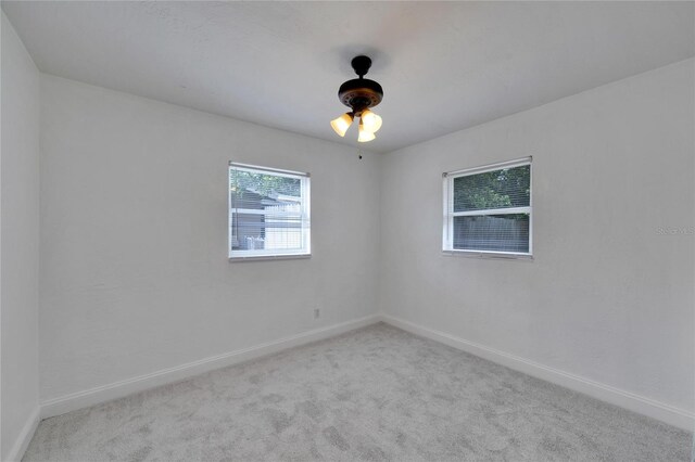 empty room with light carpet and ceiling fan