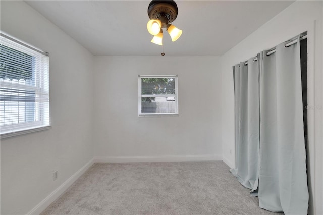 unfurnished room featuring light carpet and ceiling fan