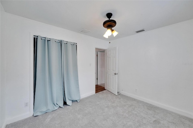 unfurnished bedroom featuring ceiling fan and light carpet