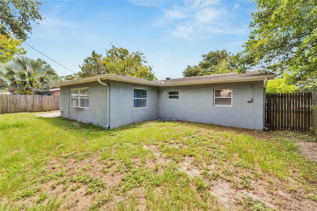 rear view of property with a yard