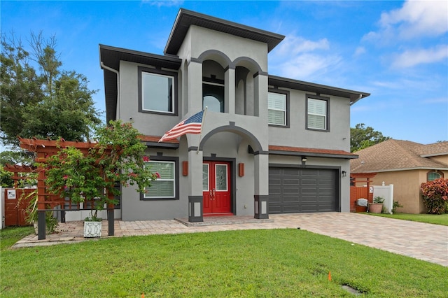 view of front of property with a front lawn and a garage