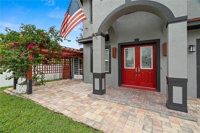 view of exterior entry featuring a pergola