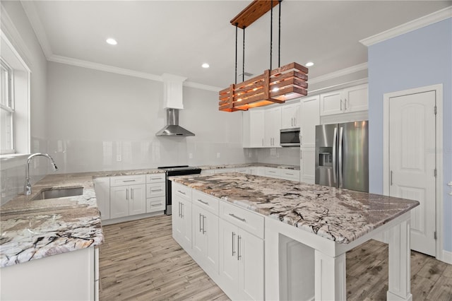 kitchen with stainless steel appliances, sink, pendant lighting, white cabinets, and a center island