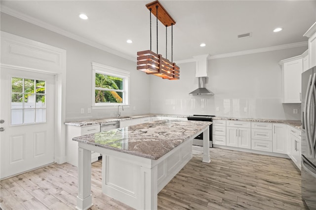 kitchen featuring pendant lighting, a center island, a breakfast bar area, white cabinetry, and stainless steel appliances