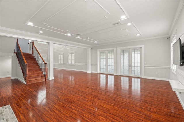 unfurnished living room with dark hardwood / wood-style floors, a healthy amount of sunlight, and crown molding